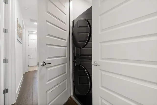 a view of a hallway with wooden floor and staircase