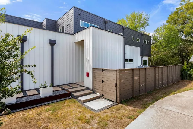 a view of a backyard with wooden fence