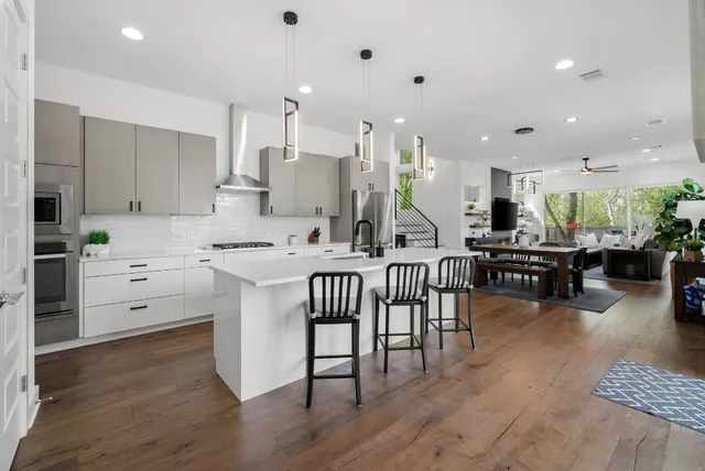 a kitchen with a table chairs stove and cabinets