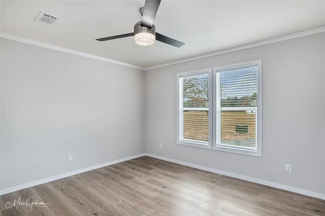 a view of an empty room with windows