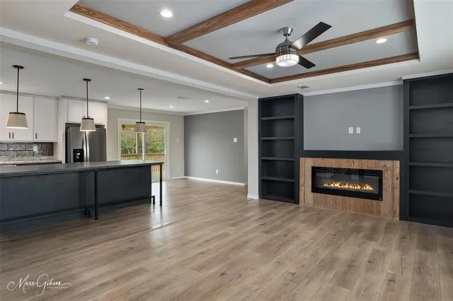 a view of a kitchen with refrigerator and a fireplace