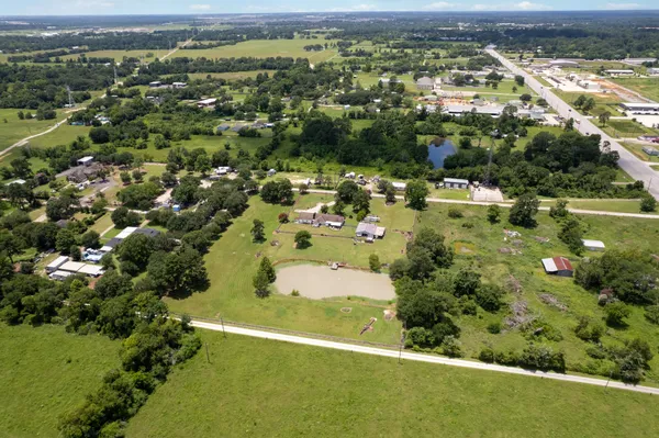 an aerial view of residential houses with outdoor space