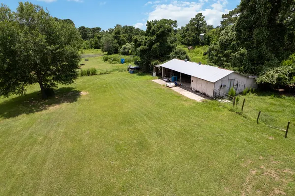 a view of a house with a yard and sitting area
