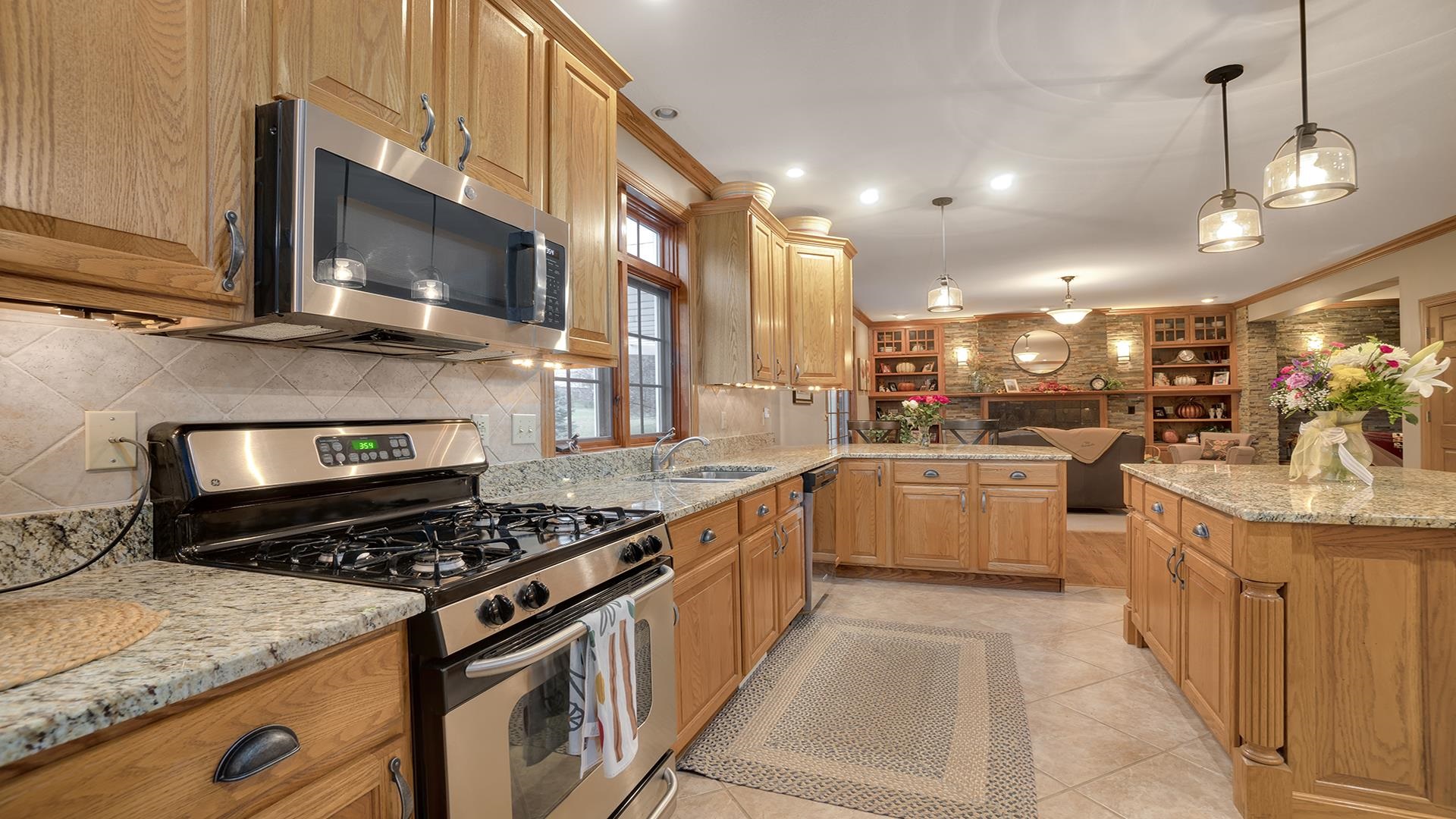 1921 Wildcat Road Dixon, IL 61021 - Photo 15 of 63 a kitchen with stainless steel appliances kitchen island granite countertop a stove and a sink