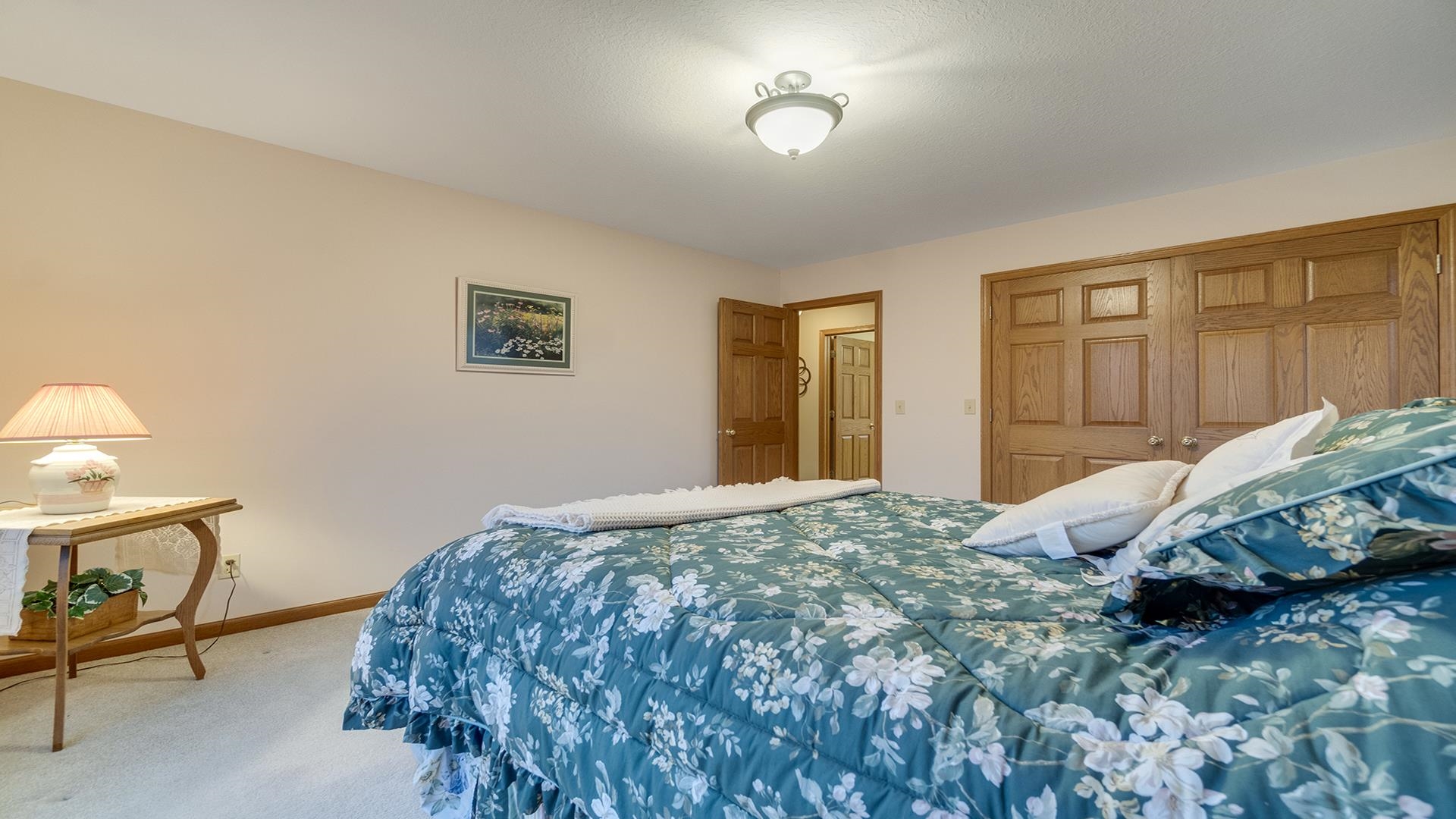 1921 Wildcat Road Dixon, IL 61021 - Photo 35 of 63 a bedroom with a bed and a dresser with rug