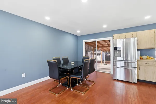 a dining room with furniture and wooden floor