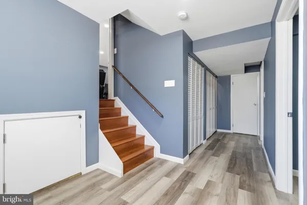 a view of a hallway with wooden floor and entryway