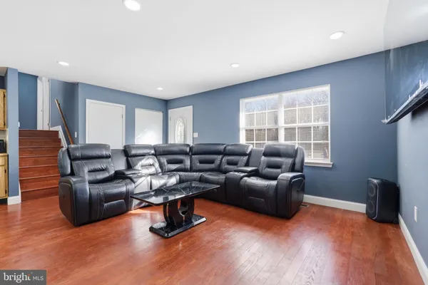 a living room with furniture window and wooden floor