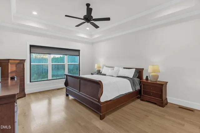 a spacious bedroom with a bed and a large window