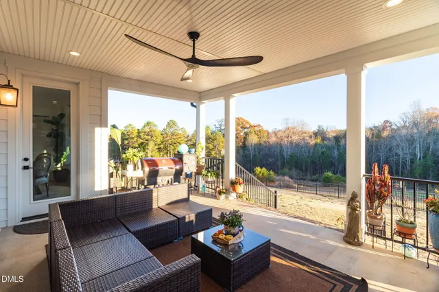a living room with furniture and a floor to ceiling window