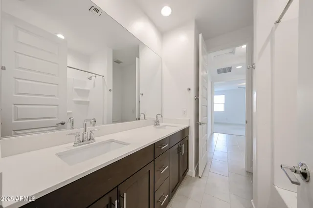 a bathroom with a sink double vanity and a mirror