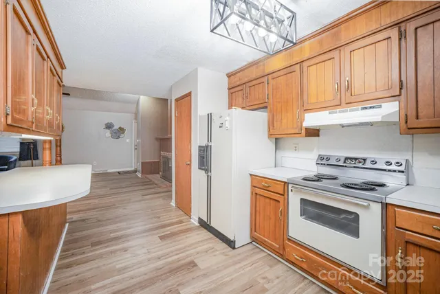 a kitchen with stainless steel appliances a stove a refrigerator and cabinets