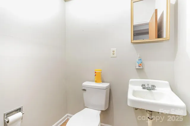 a white toilet sitting next to a white sink
