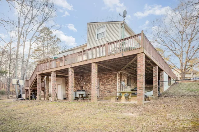 a view of a house with large windows and a tree