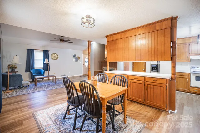 a dining room with furniture wooden floor and a rug