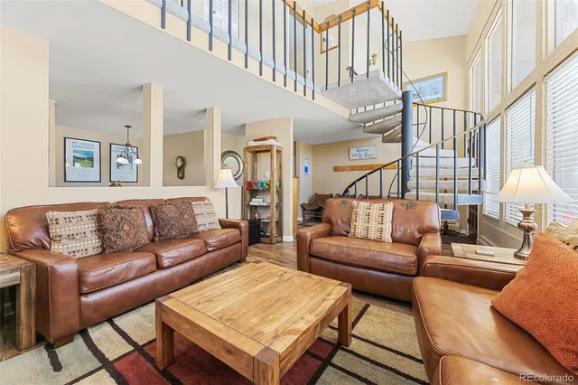 a living room with furniture and a potted plant