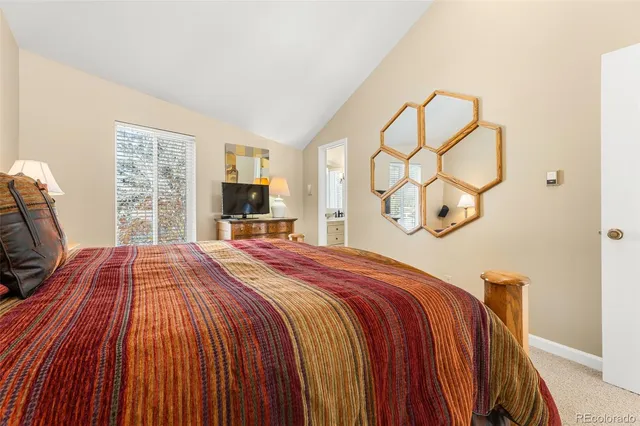 a bedroom with a large bed and a tv on the dresser