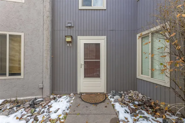 a front view of a house with a potted plant