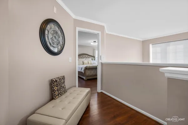 a view of a bedroom with a bed and a chair