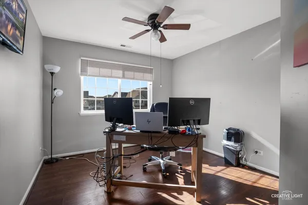 a view of a workspace with furniture and a window