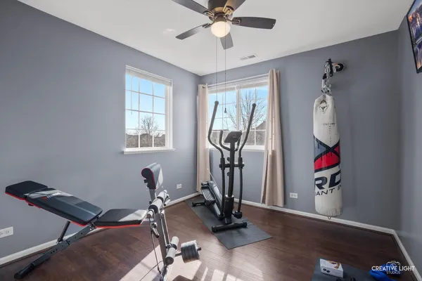 a room with gym equipment and windows