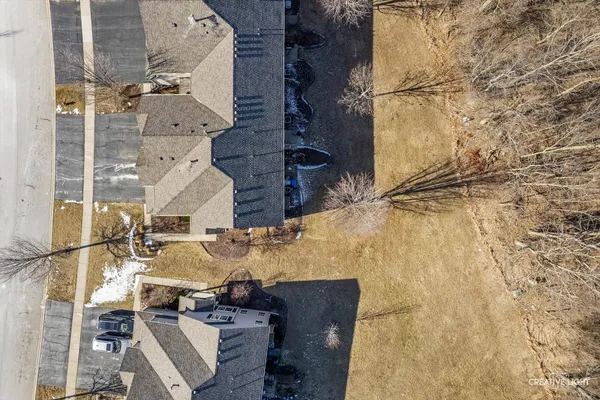 an aerial view of residential houses with outdoor space