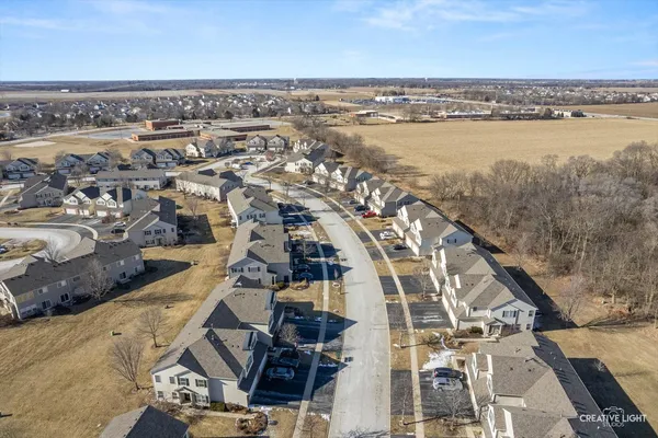 an aerial view of residential building and lake