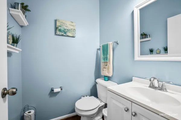 a bathroom with a toilet a sink and mirror