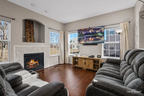 a living room with furniture and a fireplace