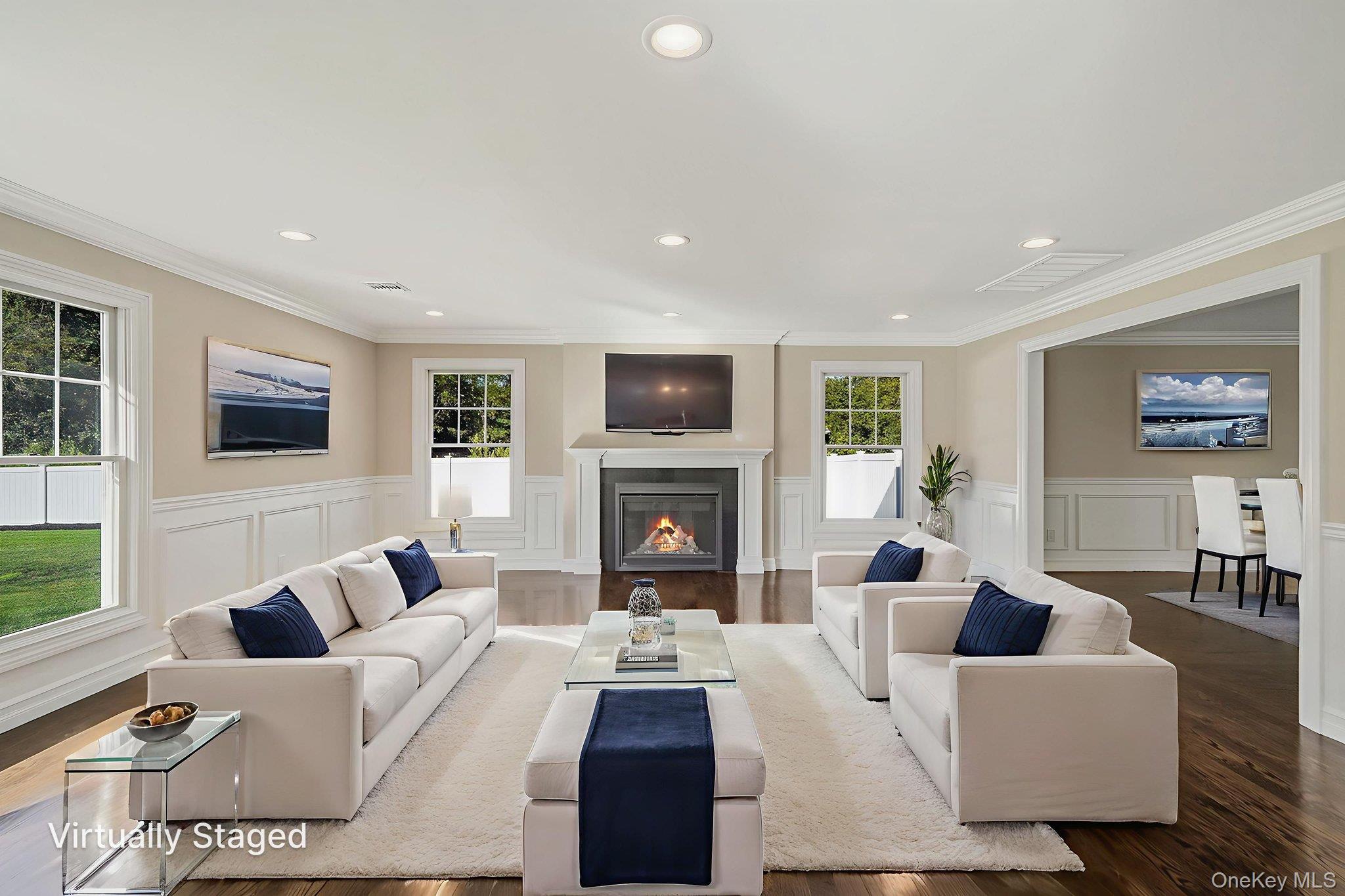 14 Quintree Lane Melville, NY 11747 - Photo 11 of 46 a living room with furniture a fireplace and a flat screen tv