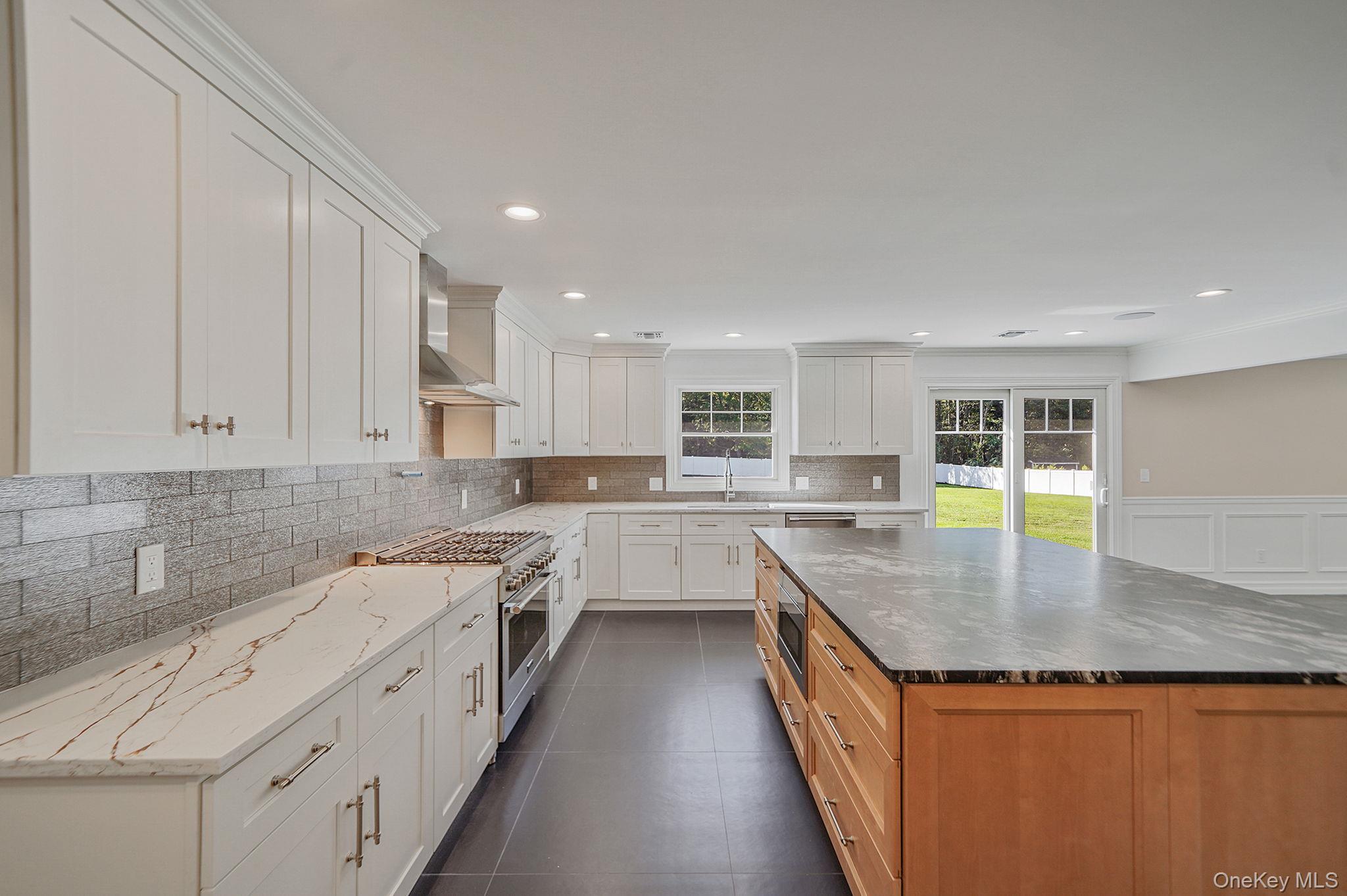 14 Quintree Lane Melville, NY 11747 - Photo 16 of 46 a kitchen with stainless steel appliances granite countertop sink stove and cabinets