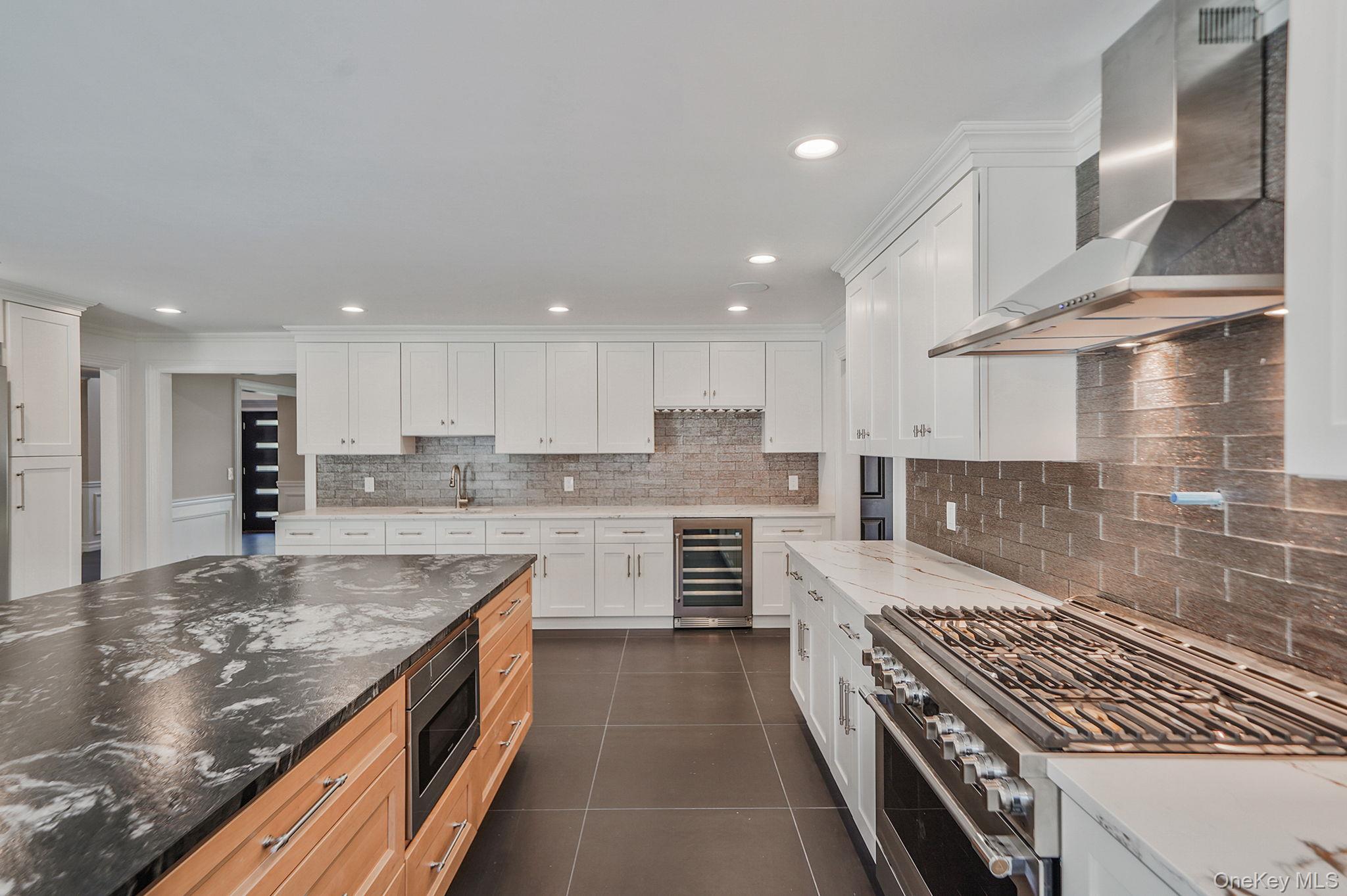 14 Quintree Lane Melville, NY 11747 - Photo 17 of 46 a kitchen with stainless steel appliances granite countertop a stove a sink and a refrigerator
