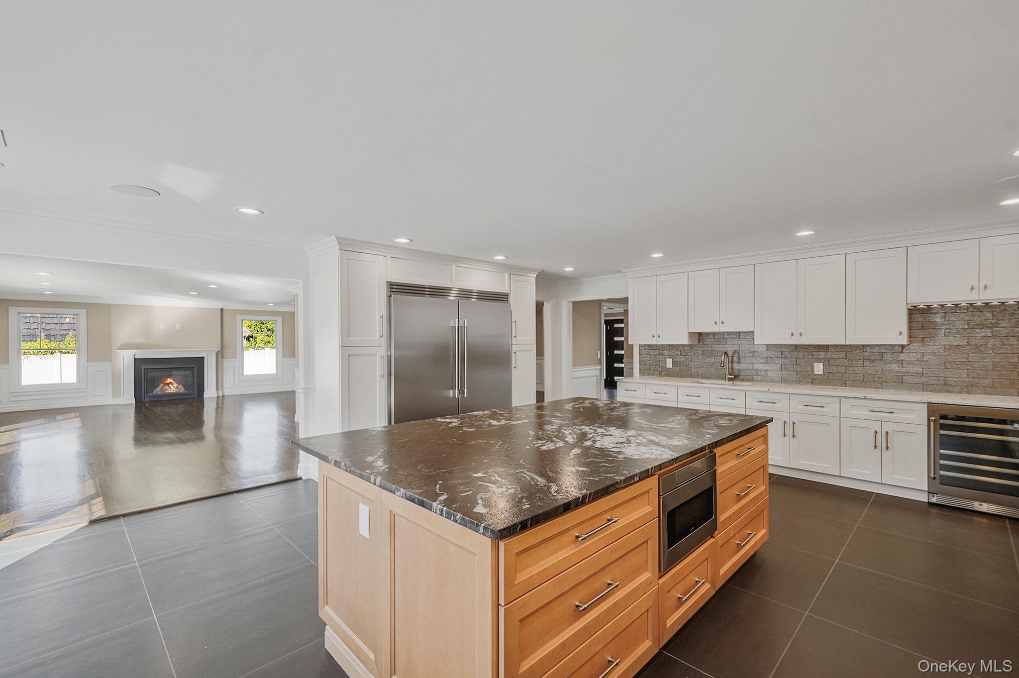 14 Quintree Lane Melville, NY 11747 - Photo 18 of 46 a kitchen with stainless steel appliances granite countertop a sink and a refrigerator