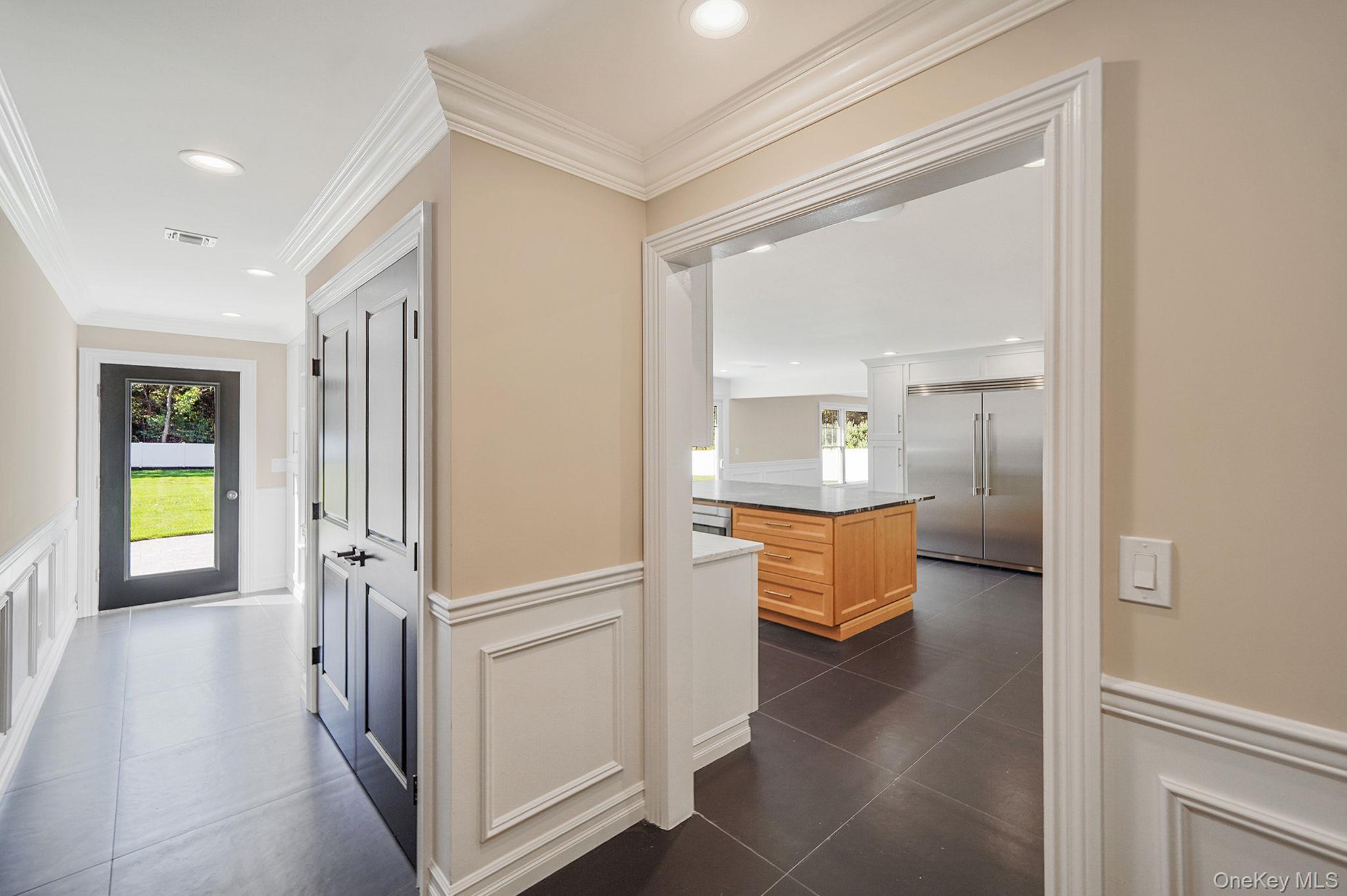 14 Quintree Lane Melville, NY 11747 - Photo 19 of 46 a view of a hallway view with wooden floor and dining room