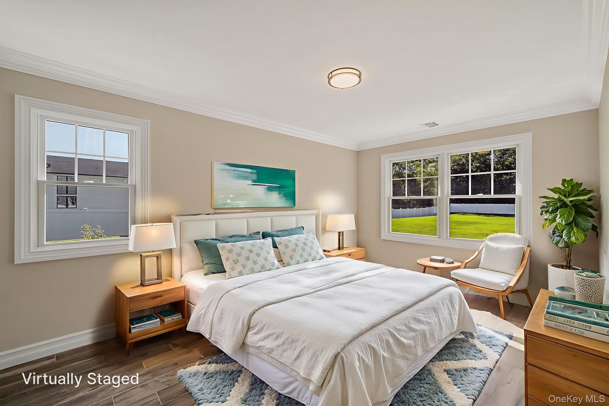 14 Quintree Lane Melville, NY 11747 - Photo 22 of 46 a spacious bedroom with a bed a table and a window