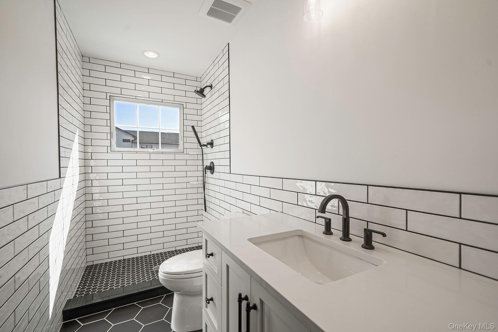 14 Quintree Lane Melville, NY 11747 - Photo 23 of 46 a bathroom with a sink toilet and shower