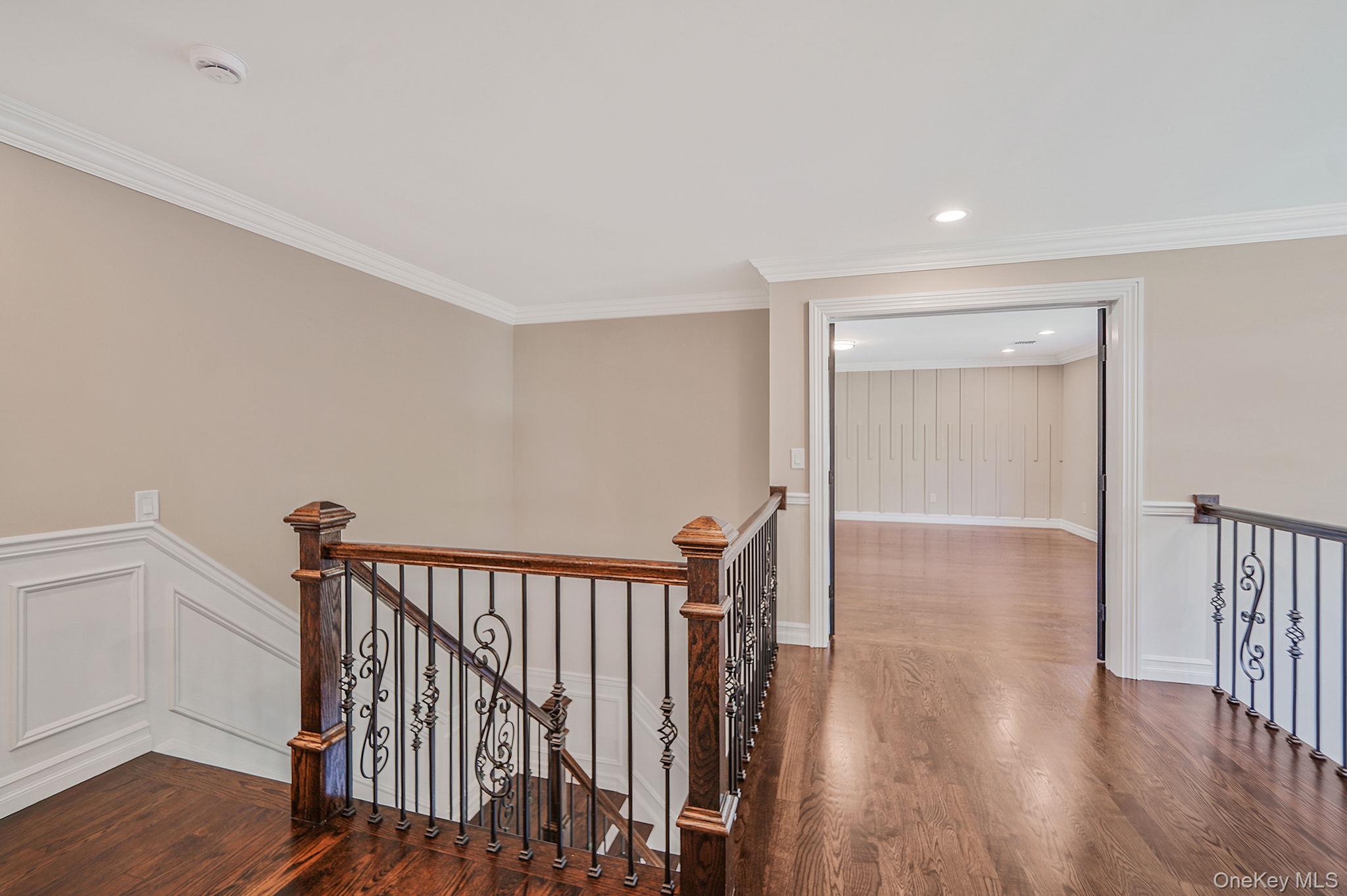 14 Quintree Lane Melville, NY 11747 - Photo 26 of 46 a view of a hallway with wooden floor and a window