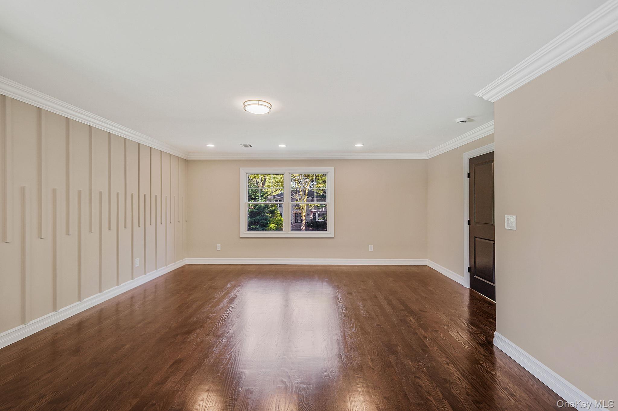 14 Quintree Lane Melville, NY 11747 - Photo 27 of 46 an empty room with wooden floor and windows