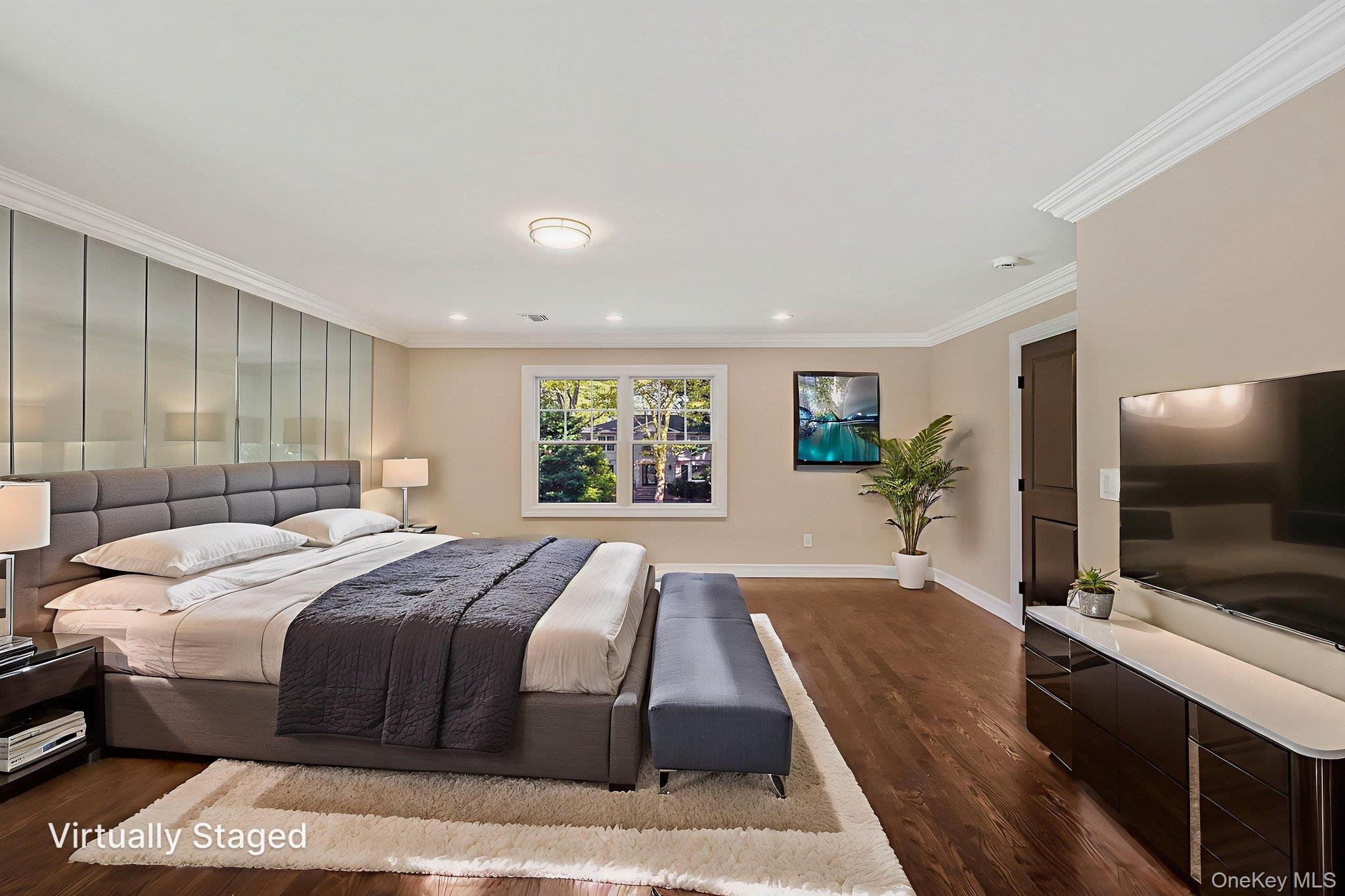 14 Quintree Lane Melville, NY 11747 - Photo 28 of 46 a spacious bedroom with a large bed and a flat screen tv