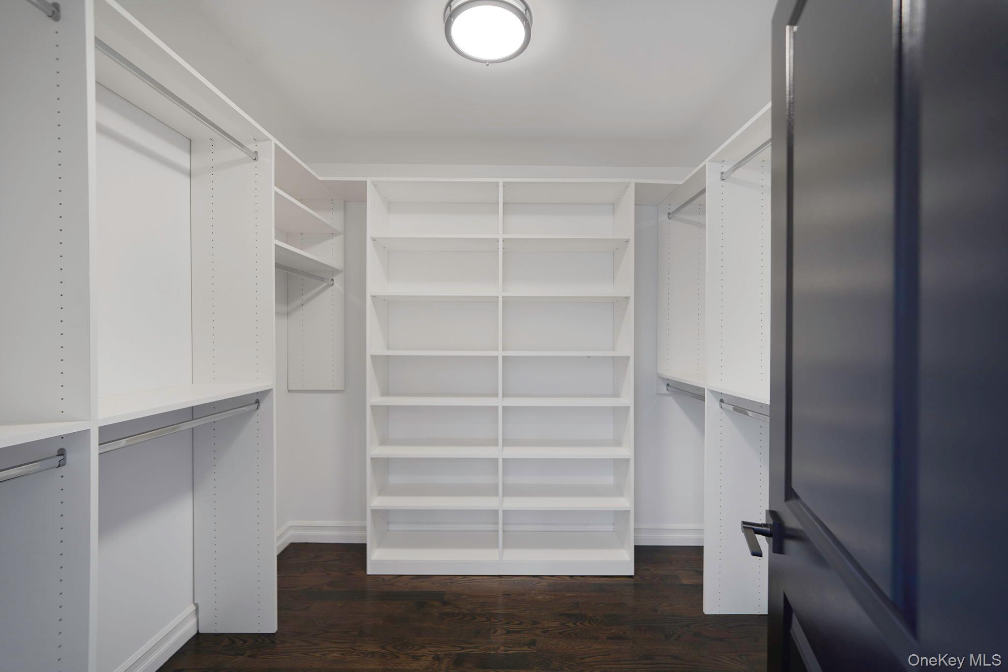 14 Quintree Lane Melville, NY 11747 - Photo 30 of 46 a view of walk in closet with empty racks