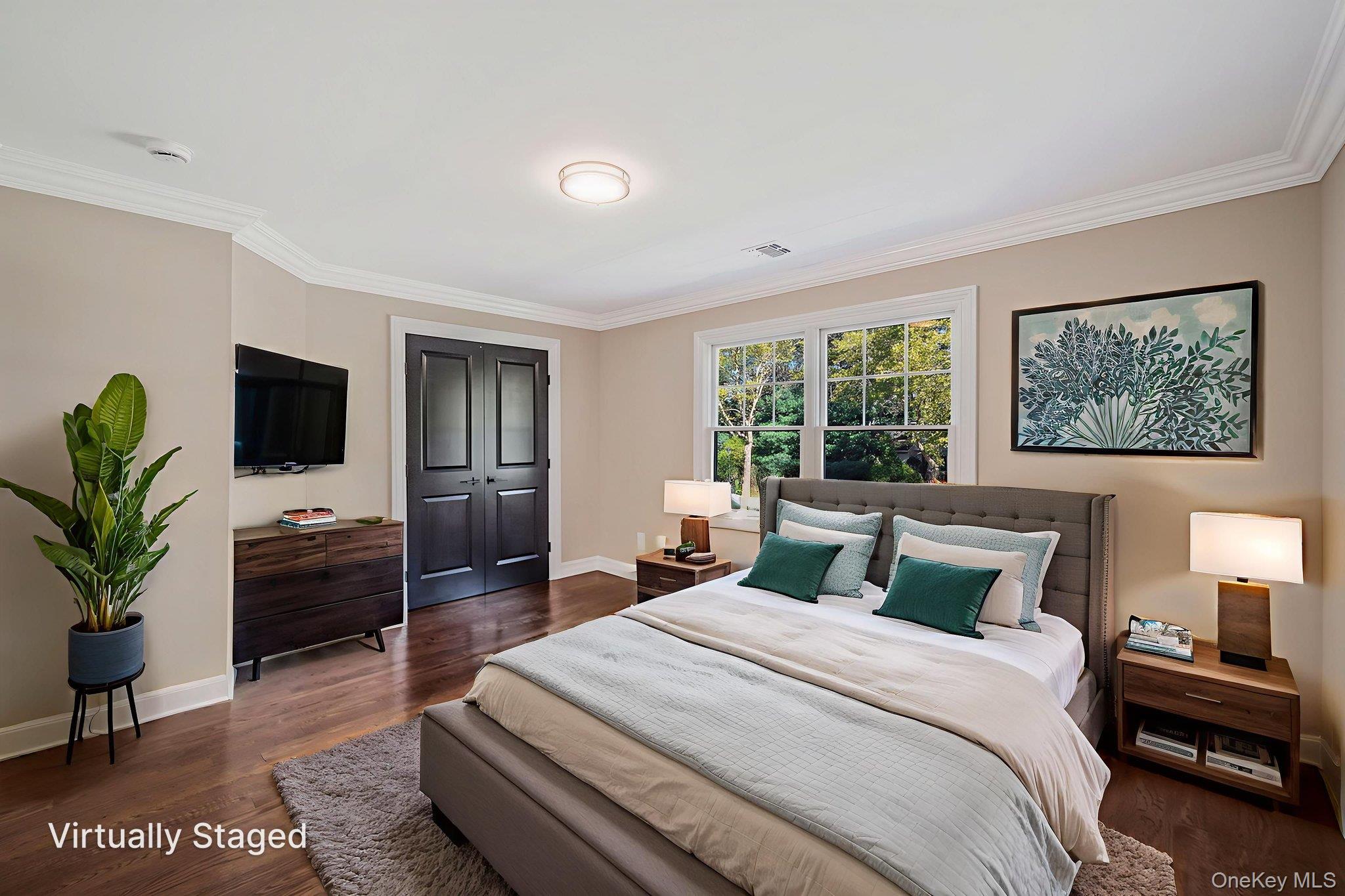 14 Quintree Lane Melville, NY 11747 - Photo 33 of 46 a bedroom with a large bed and a flat screen tv