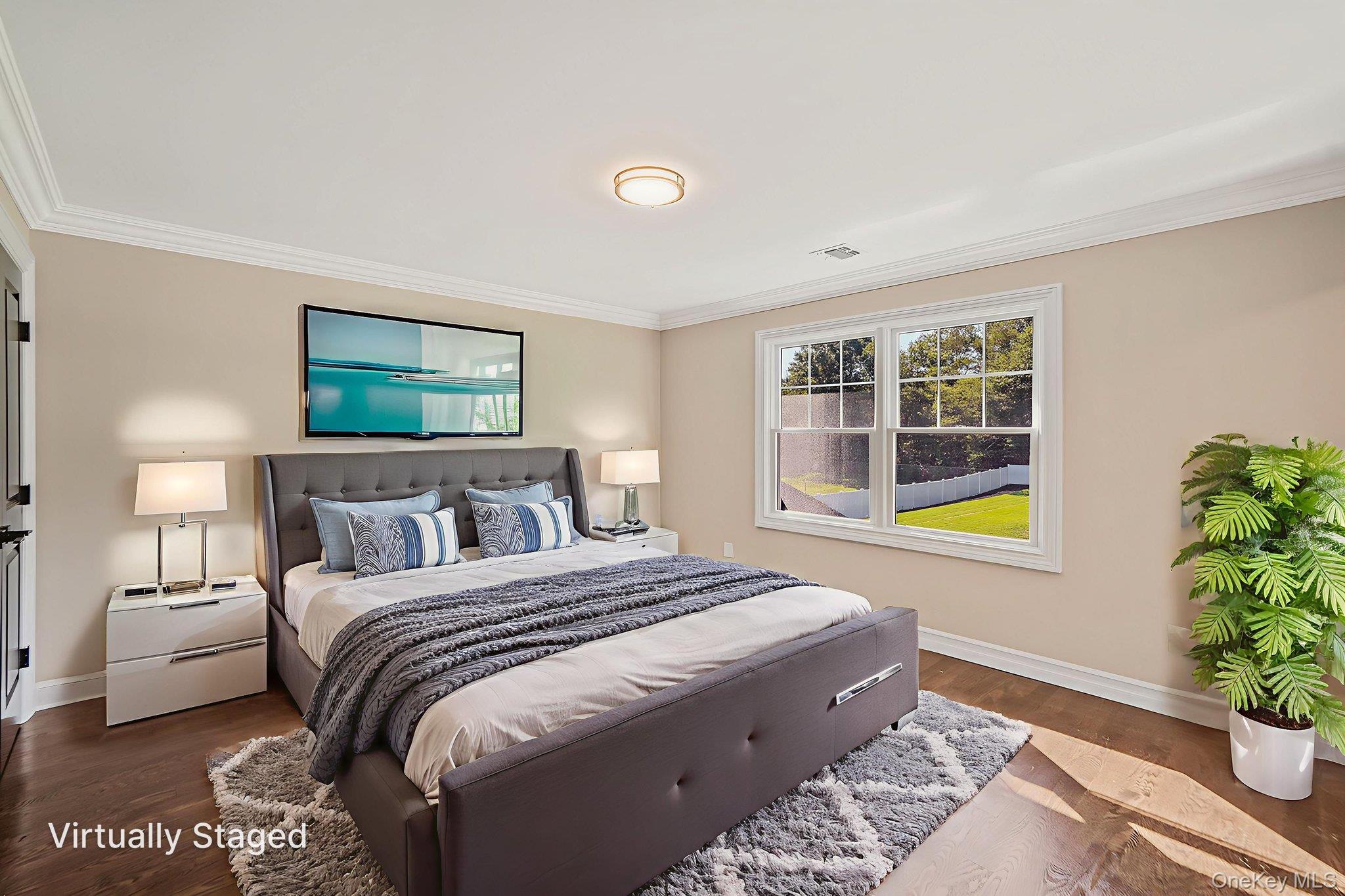 14 Quintree Lane Melville, NY 11747 - Photo 34 of 46 a bedroom with a bed and a potted plant