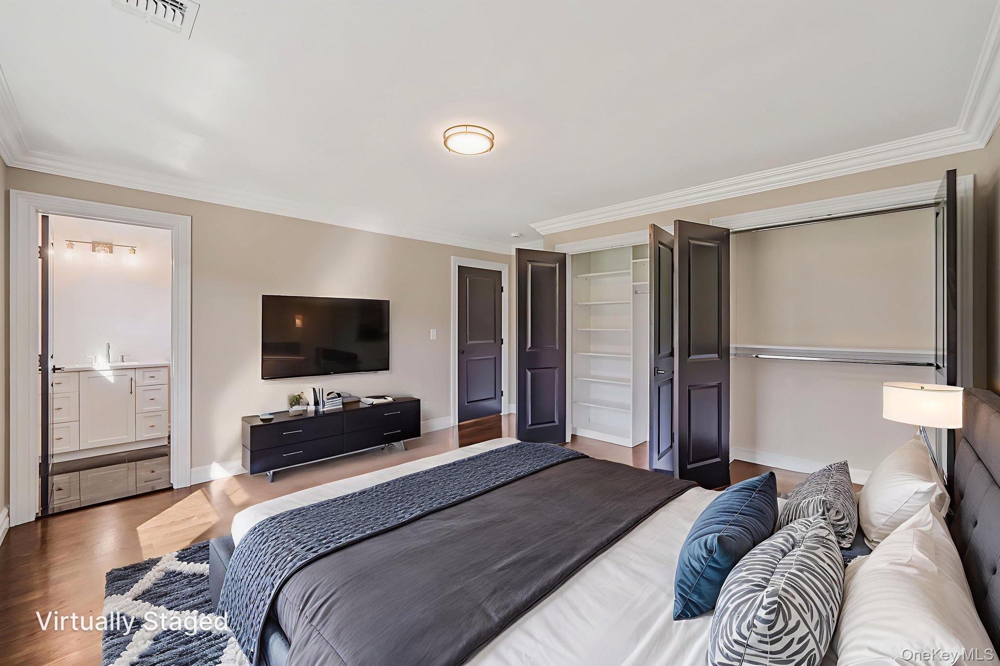 14 Quintree Lane Melville, NY 11747 - Photo 36 of 46 a bedroom with a bed and a flat screen tv