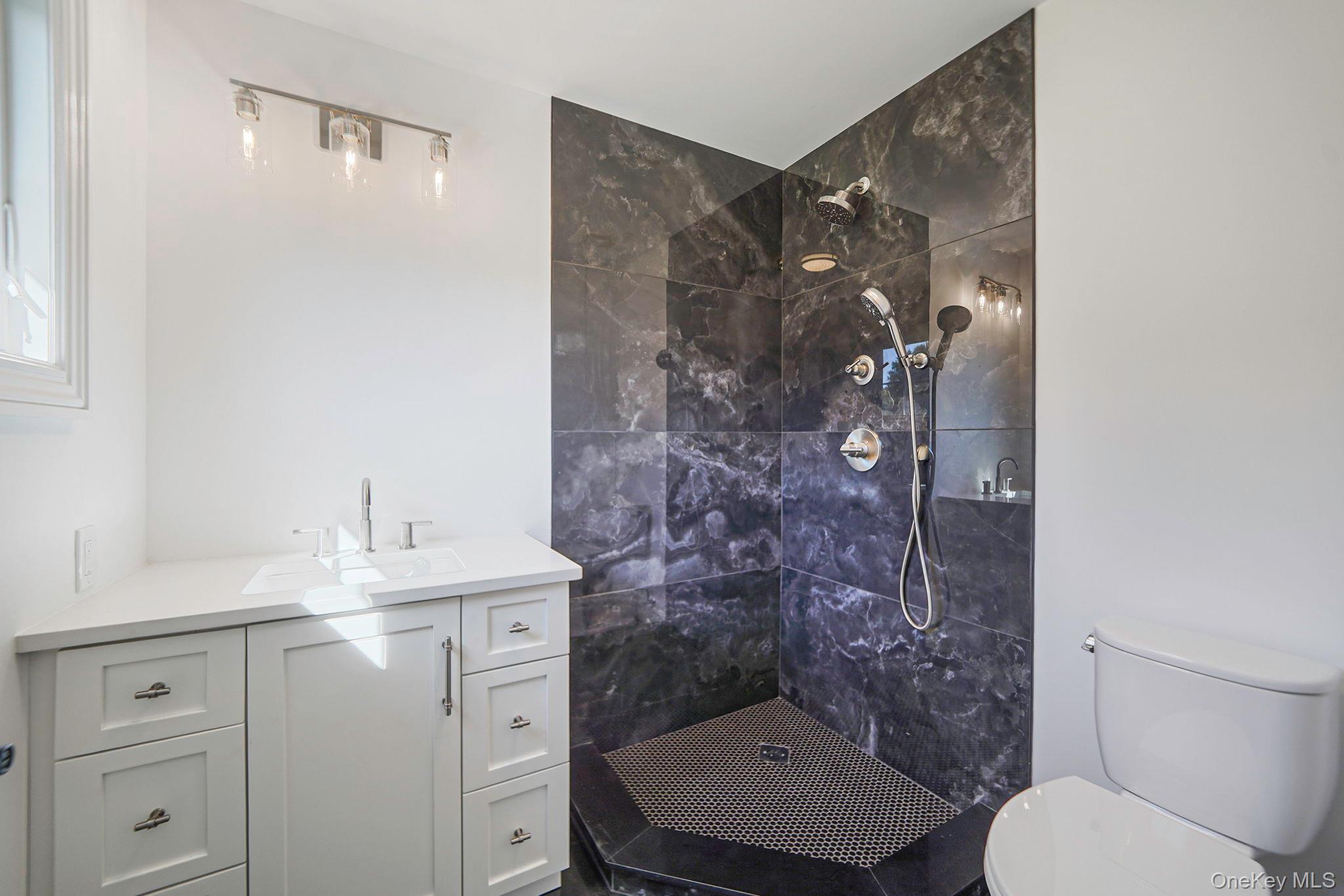 14 Quintree Lane Melville, NY 11747 - Photo 37 of 46 a bathroom with a sink toilet and shower