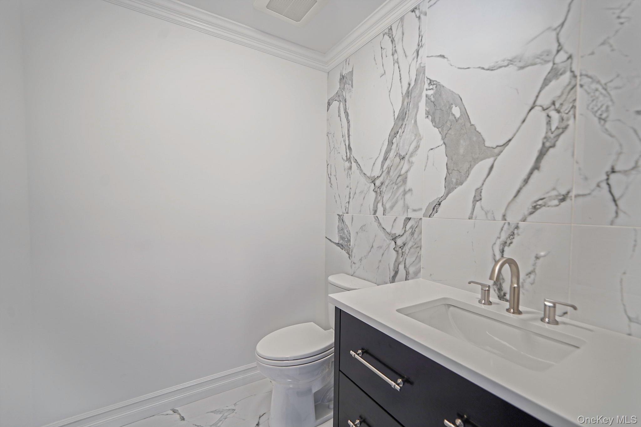 14 Quintree Lane Melville, NY 11747 - Photo 7 of 46 a bathroom with a granite countertop sink a toilet and with a mirror