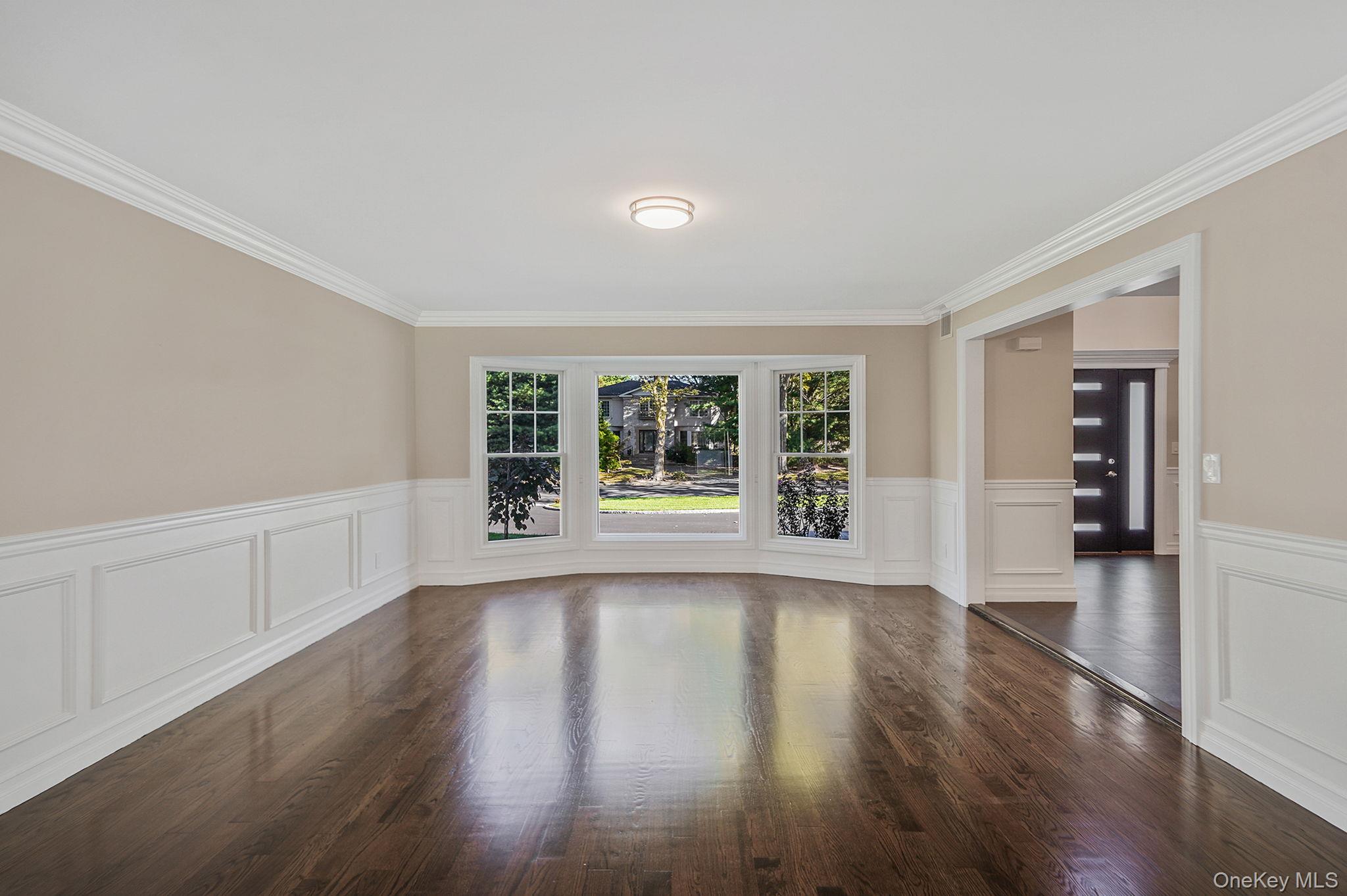 14 Quintree Lane Melville, NY 11747 - Photo 8 of 46 a view of an empty room with wooden floor and a window