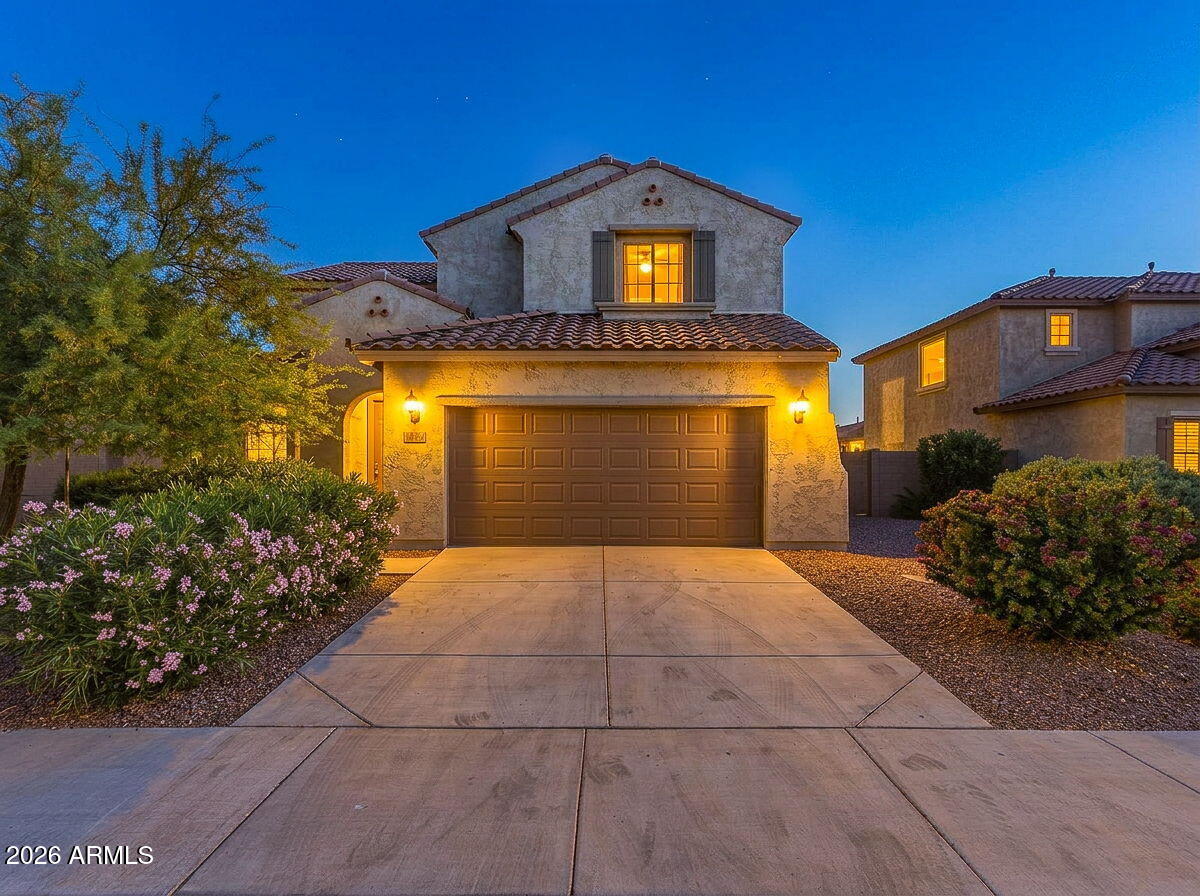 17543 West Buckhorn Trail Surprise, AZ 85387 - Photo 1 of 104 a front view of a house with garden