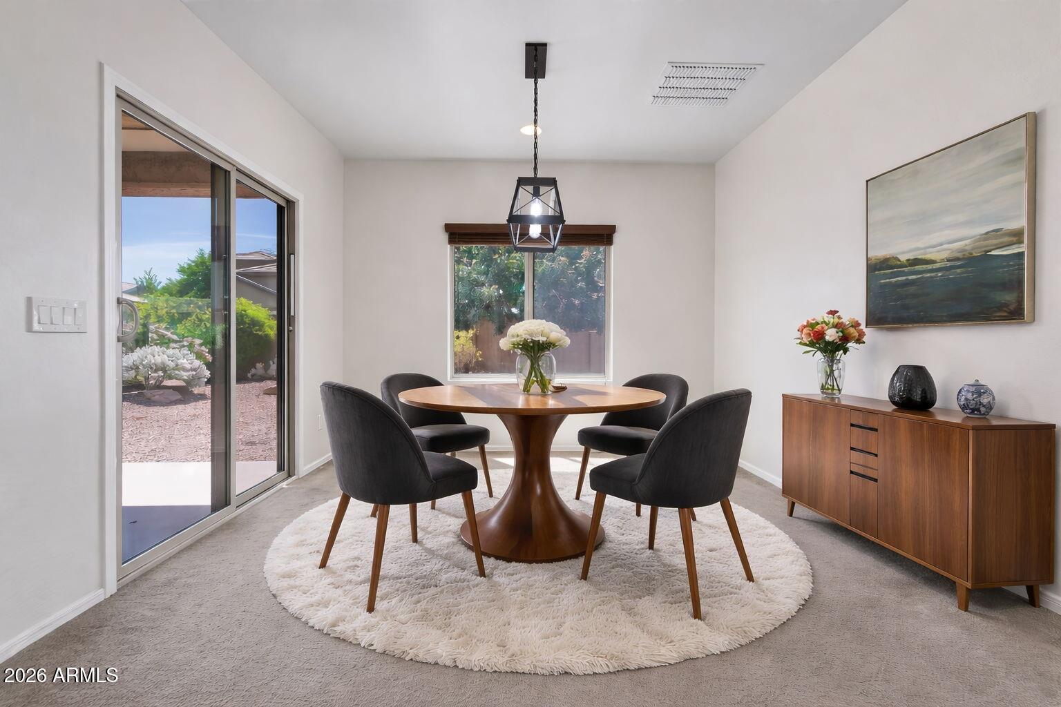 17543 West Buckhorn Trail Surprise, AZ 85387 - Photo 13 of 104 a dining room with furniture a flat screen tv and a large window