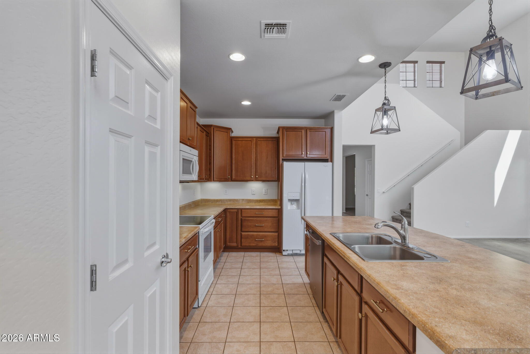 17543 West Buckhorn Trail Surprise, AZ 85387 - Photo 21 of 104 a kitchen with stainless steel appliances granite countertop a sink stove and refrigerator