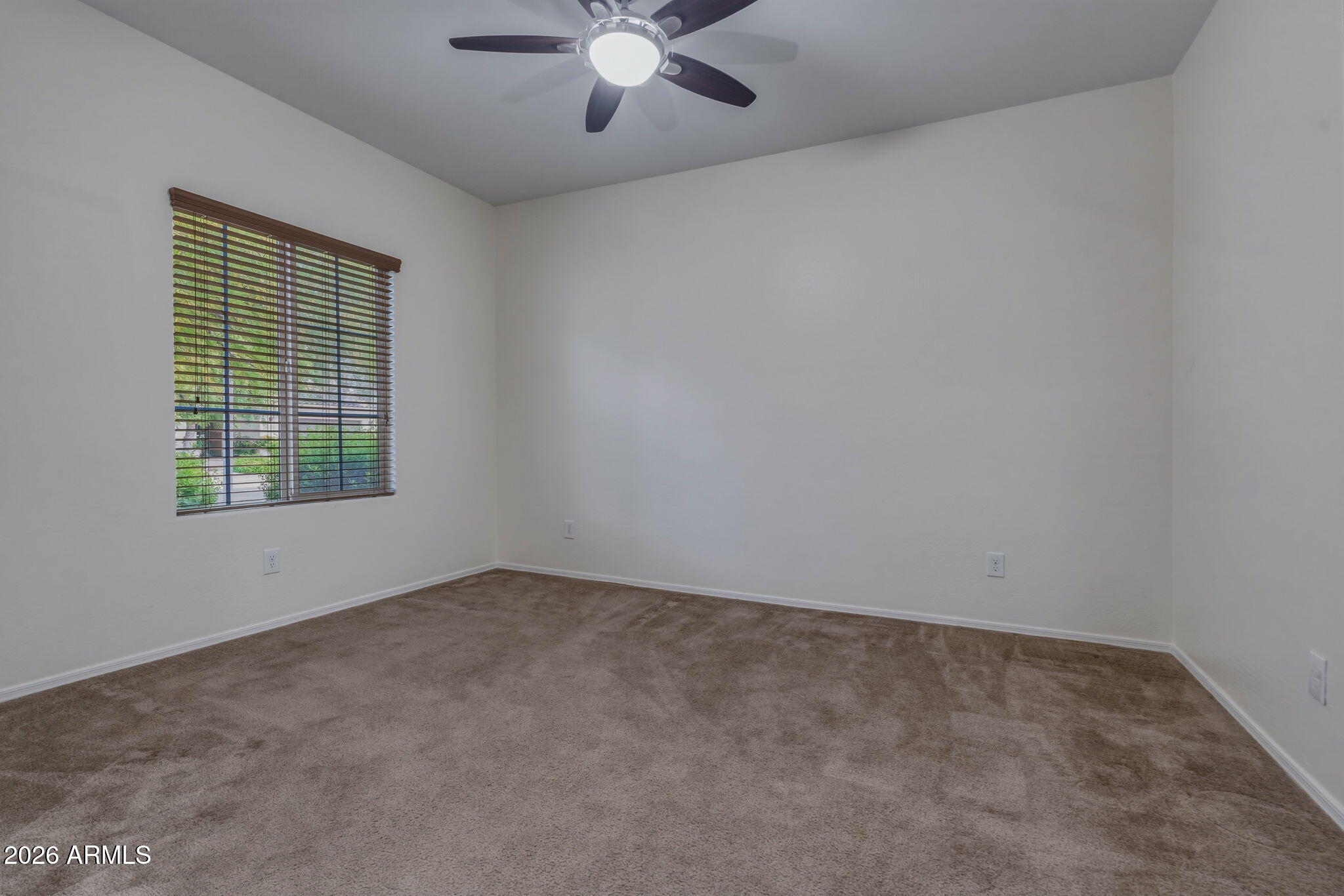 17543 West Buckhorn Trail Surprise, AZ 85387 - Photo 25 of 104 an empty room with a window and a ceiling fan